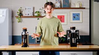 Talent in between the DF64 and Eureka Zero 65 Espresso Grinders showing them off, lifestyle by Clive Coffee