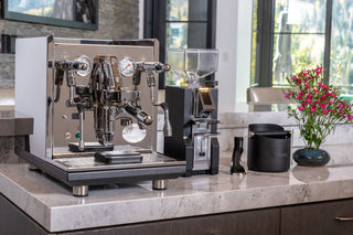 ECM Synchronika II espresso machine with chrome finish and dual group heads on a marble counter