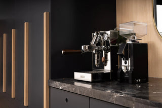 Professional espresso machine with chrome finish and a clear hopper on a marble counter LUCCA branding visible