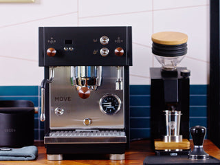 Profitec MOVE espresso machine front view with copper knobs and portafilter mounted