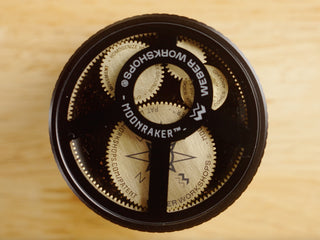 Two Weber Workshops boxes on a wooden table with logo visible