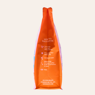 Bright Eyed Breakfast orange coffee bag with How to Recharge instructions visible on the front