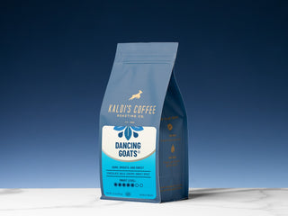 Dancing Goats blend coffee bag standing upright against a deep blue background with the Dancing Goats label.