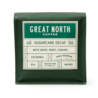 Green bag labeled Great North Coffee Sugarcane Decaf with Colombia origin details on a white label