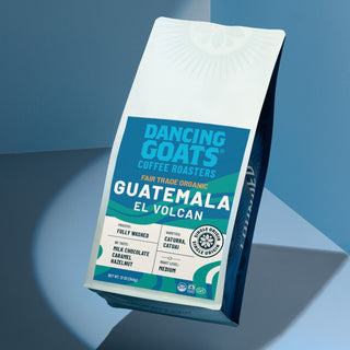 Tilted Dancing Goats Guatemala El Volcán coffee package with bold blue label.