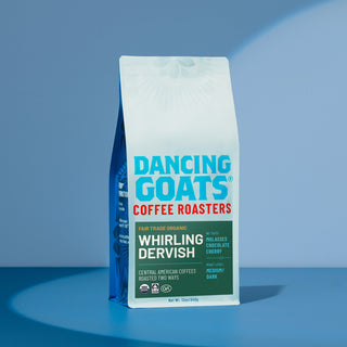 Organic Whirling Dervish Dancing Goats coffee bag with white packaging and large blue Dancing Goats text against a blue backdrop