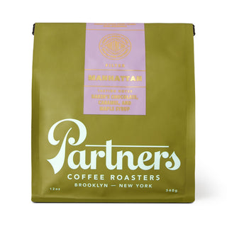 Bag of Partners Manhattan coffee roast in olive green packaging with lavender label