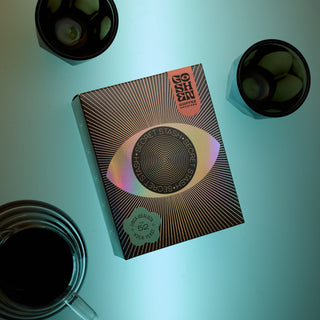 Overhead view of Secret Stash No 52 Kveik Yeast box with two metal cups on a teal surface