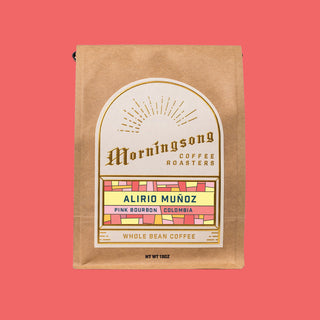 Brown kraft coffee bag from Morningsong with Alirio Muñoz Pink Bourbon Colombia label on a coral background