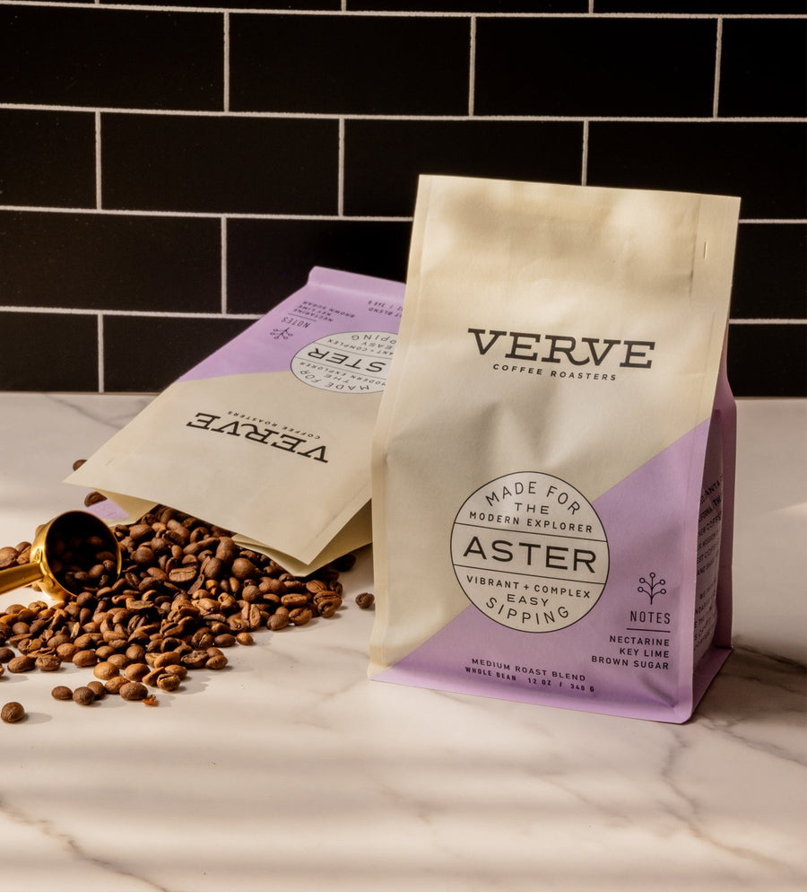 Close-up of fresh coffee grounds being dosed into a portafilter