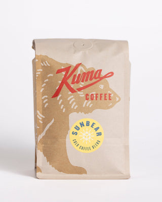 Sun Bear Cold Coffee Blend bag featuring a yellow circular badge and mountain artwork.