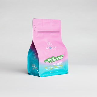 Colombia Manos Juntas Natural coffee bag with teal bottom and illustrated coffee beans