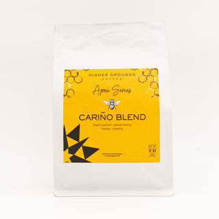 Bright yellow Apex Series Cariño Blend label on a Higher Grounds Coffee bag with honeycomb pattern and black star graphic