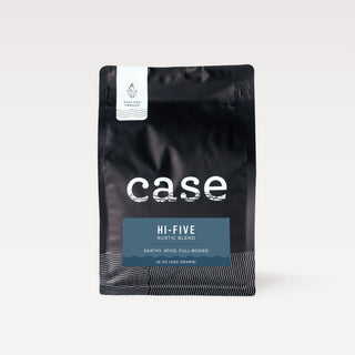 Close up of a black Case Coffee bag with a white Ashland Oregon label and a blue Hi-Five Rustic Blend badge.