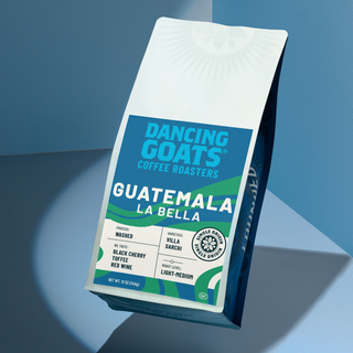 Guatemala La Bella coffee packaging from Dancing Goats shown at an angle against a blue background.