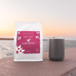 Higher Grounds Dusk Blend Apex Series coffee bag with pink label on a white bag against a sunset backdrop