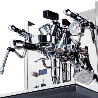 Chrome ECM Synchronika espresso machine detail with multiple fittings and the ECM badge on the front panel.