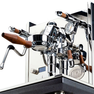 Close-up of chrome ECM Synchronika II espresso machine with wooden portafilter handles and gauge