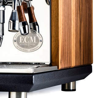 Close up of walnut wood panel on Synchronika with chrome group head and portafilters.