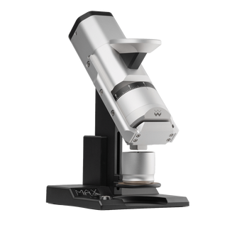 Angled side view of Weber Workshops EG-1 Mk.3 flat burr coffee grinder in silver on a black stand