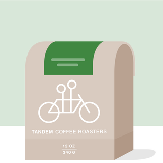Sidra Lot 2 Colombia coffee packaging on a green background with beige decorative curves and Tandem branding