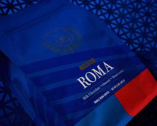 Espresso Roma packaging in blue with a gold crest and large ROMA lettering