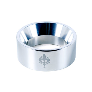 Close-up of Eureka Mignon Libra espresso grinder with polished metal finish and fleur de lis emblem on the body