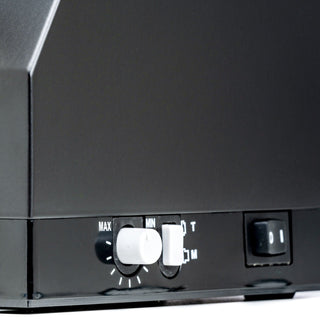 Close-up of a black Eureka Mignon Silenzio 55 espresso grinder front panel showing MAX and MIN markings and white adjustment dials.