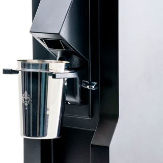 Side view of Eureka Mignon Zero 65 showing the portafilter cradle and metal spout area.