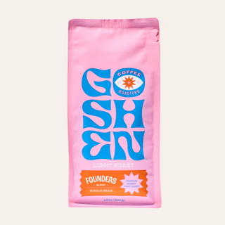 Pink bag of Goshen Coffee Founders blend with blue logo and orange label.
