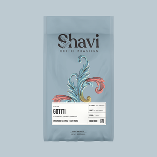 Front view of Ethiopia Gotiti coffee bag featuring the Shavi Coffee Roasters logo on a soft blue background.