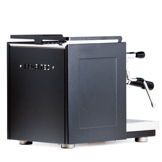 Partial front-left view of Profitec RIDE espresso machine with dark matte cabinet and metal top rail.
