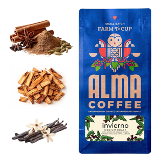 Ground coffee, cinnamon sticks, star anise, and cardamom beside a blue Alma Coffee Invierno bag labeled Farm To Cup.