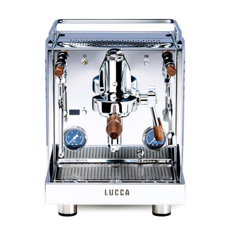 Front view of a chrome LUCCA M58 Sunto espresso machine with dual wooden portafilter handles and walnut trim