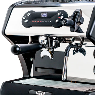 Front view of a LUCCA espresso machine with a portafilter attached to the group head and a chrome finish.