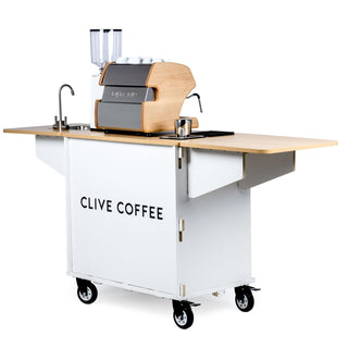 Klassy Karts turn-key mobile coffee cart featuring a LUCCA espresso machine on a light wood counter with cups on top.
