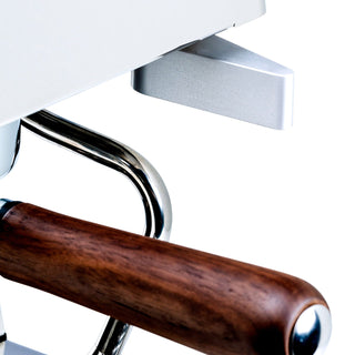 Close up of a LUCCA Tempo espresso machine portafilter with wooden handle and chrome lever