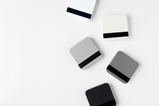 Several Acaia Lunar scales in different colors arranged on a white surface