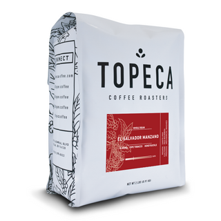 Topeca El Salvador El Manzano coffee bag close up with white packaging and red label.