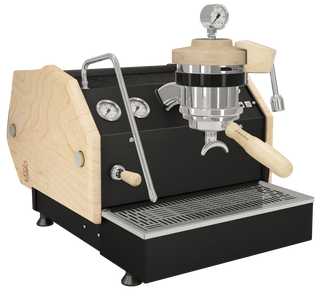 La Marzocco GS3 espresso machine with natural wood side panels, chrome fittings, gauges, and a manual paddle lever.