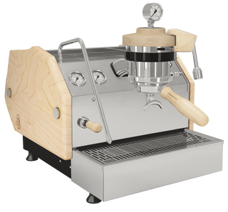 La Marzocco GS3 espresso machine with light wood side panels and chrome hardware, front view with gauges and wooden handle.