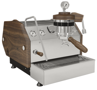 La Marzocco GS3 espresso machine with dark wood side panels and chrome accents, visible portafilter and pressure gauge.