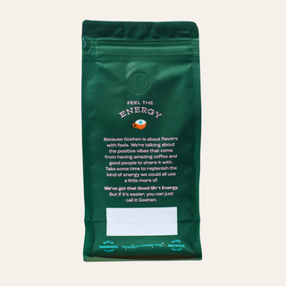 Dark green coffee bag with a circular vent and energy branding on the front