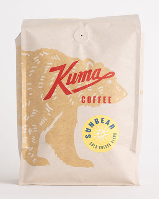 Sun Bear Cold Coffee Blend packaging from the side with a large tan map graphic and yellow badge on kraft bag.