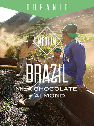 Organic Brazil Fazenda Dutra coffee packaging featuring farm workers and a bold BRAZIL label with Milk Chocolate Almond flavor