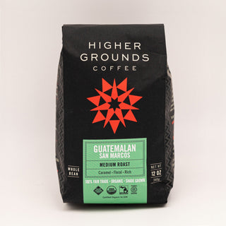Guatemalan San Marcos coffee bag by Higher Grounds on a black package with white logo and a red geometric star