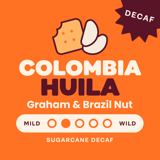 Decaf Colombia Huila coffee hero on orange background with a cartoon hand and a DECAF badge