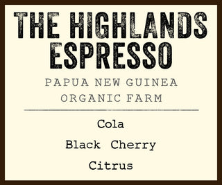 Label card for The Highlands Espresso showing Papua New Guinea branding and tasting notes Cola Black Cherry Citrus