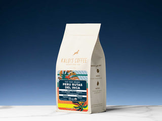 Kaldi's Coffee Peru Rutas del Inca bag with a vibrant label on a white package against a deep blue gradient background.