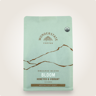 Mint green Organic Bloom coffee bag from Wonderstate with mountains graphic and USDA Organic badge